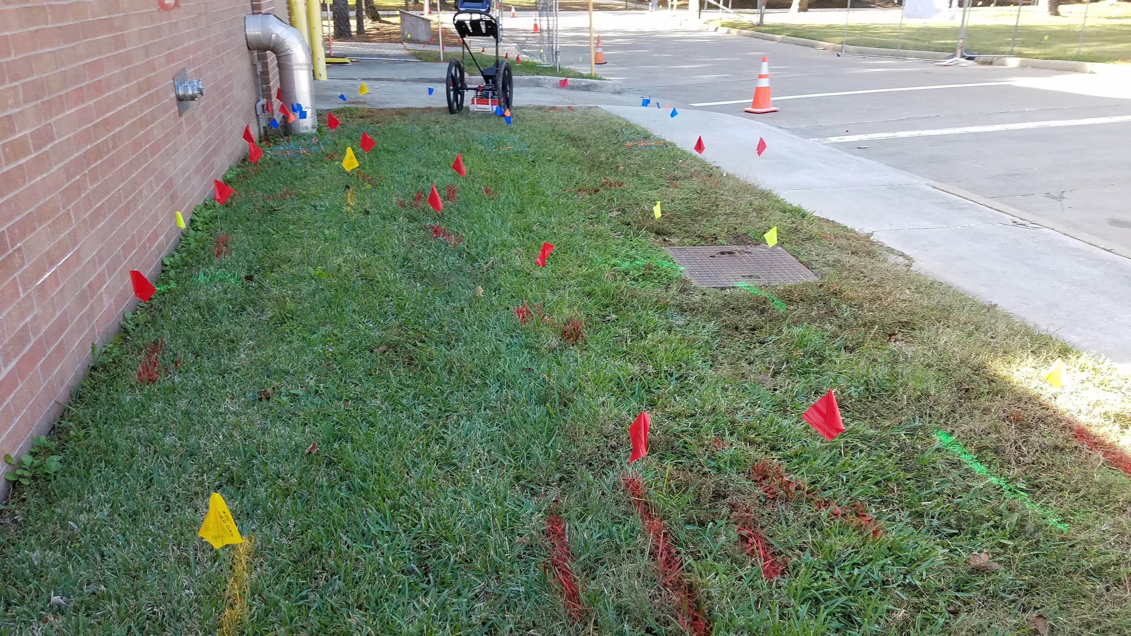 A GPR/EM scanning specialist marking utility lines on a project site.
