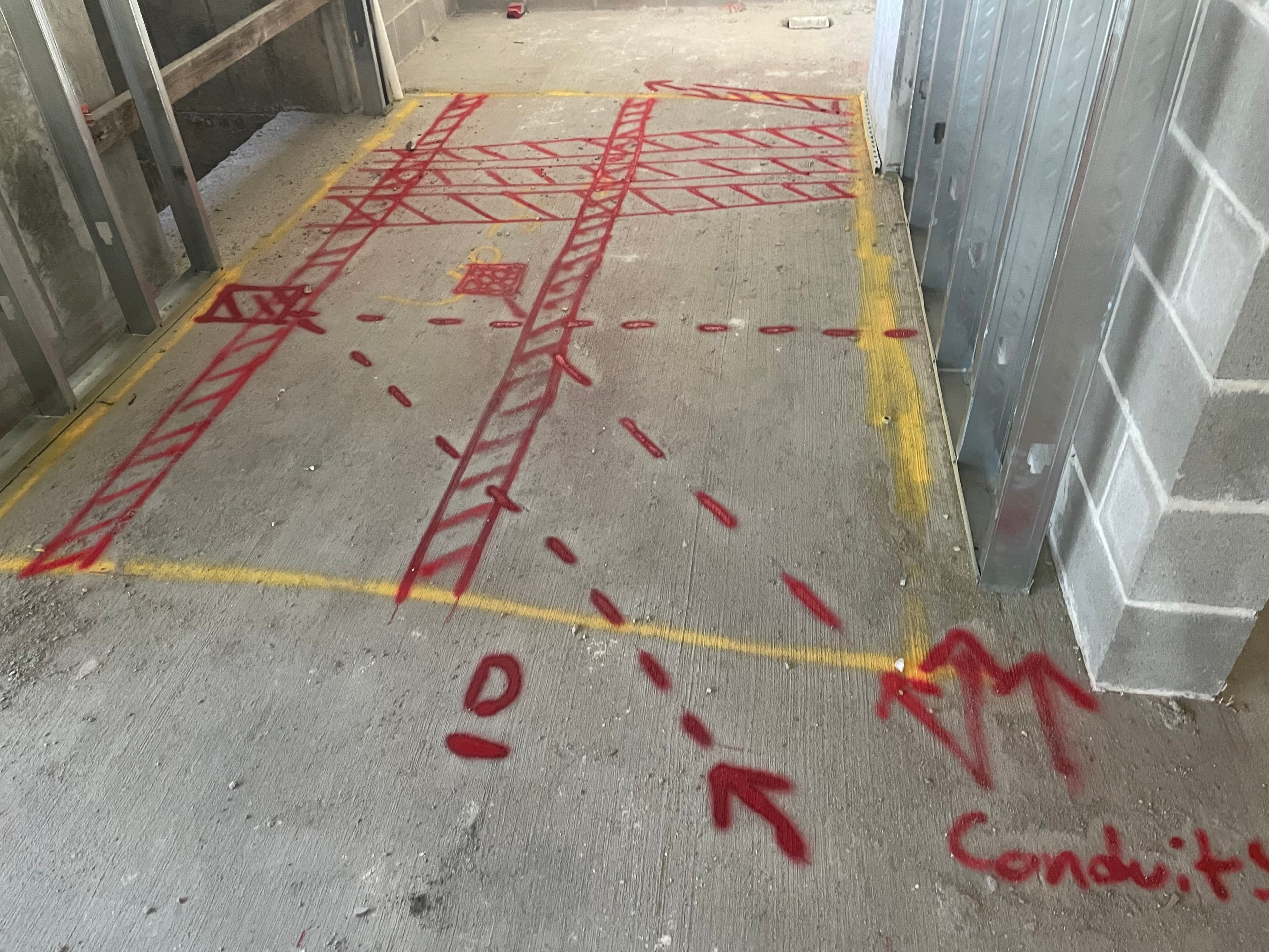 Specialist operating ground penetrating radar equipment on a construction site.